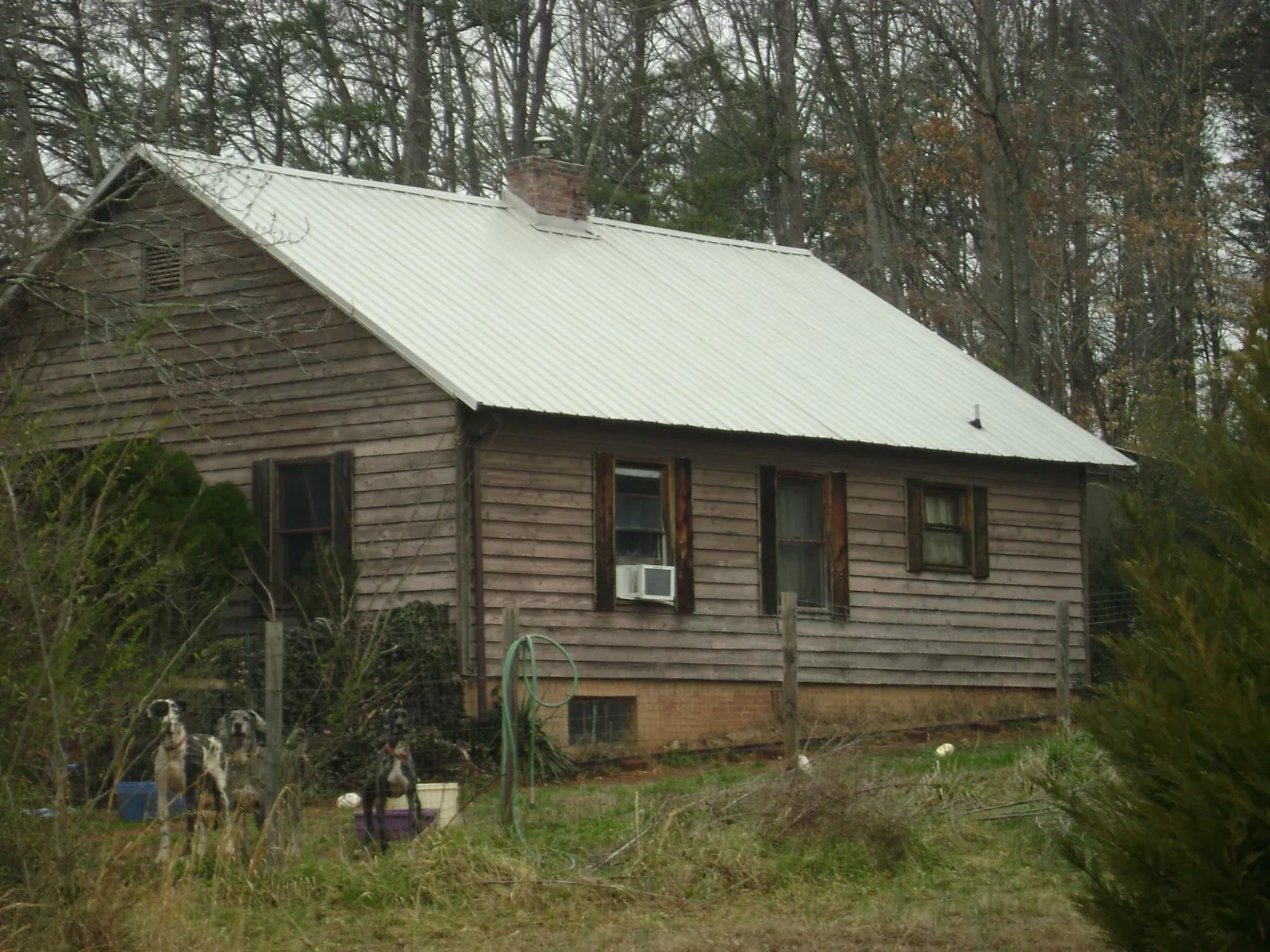 White metal roof on an old wood sided farmhouse, from a Metal Roof Installation job in Lindenhurst
